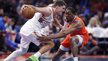 Nov 28, 2025; Oklahoma City, Oklahoma, USA; Phoenix Suns guard Collin Gillespie (12) moves the ball as Oklahoma City Thunder guard Jalen Williams (8) defends during the second half at Paycom Center. Mandatory Credit: Alonzo Adams-Imagn Images