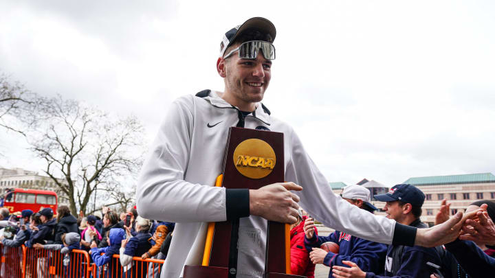 Apr 13, 2024; Hartford, CT, USA; UConn Huskies center Donovan Clingan (32) hold the championship trophy as he arrives at the State Capitol and greeted by fans before teams victory parade. Mandatory Credit: David Butler II-USA TODAY Sports