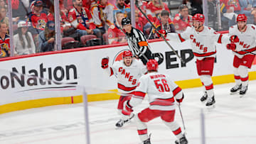 May 24, 2025; Sunrise, Florida, USA; Carolina Hurricanes center Logan Stankoven (22) and Carolina Hurricanes defenseman Scott Morrow (56) celebrate after scoring a goal during the second period in game three of the Eastern Conference Final of the 2025 Stanley Cup Playoffs at Amerant Bank Arena. Mandatory Credit: Sam Navarro-Imagn Images