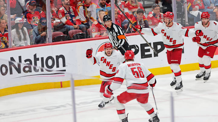 May 24, 2025; Sunrise, Florida, USA; Carolina Hurricanes center Logan Stankoven (22) and Carolina Hurricanes defenseman Scott Morrow (56) celebrate after scoring a goal during the second period in game three of the Eastern Conference Final of the 2025 Stanley Cup Playoffs at Amerant Bank Arena. Mandatory Credit: Sam Navarro-Imagn Images