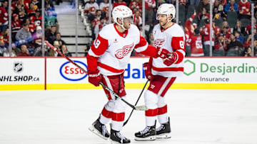 Feb 1, 2025; Calgary, Alberta, CAN; Detroit Red Wings center Andrew Copp (18) celebrates with defenseman Ben Chiarot (8) after scoring an empty net goal against the Calgary Flames during the third period at Scotiabank Saddledome. Mandatory Credit: Brett Holmes-Imagn Images