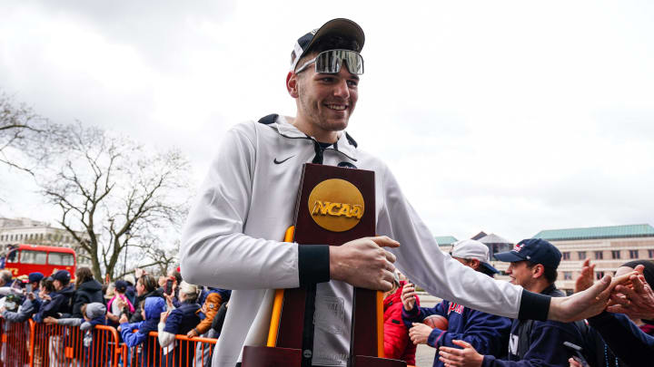 Apr 13, 2024; Hartford, CT, USA; UConn Huskies center Donovan Clingan (32) hold the championship trophy as he arrives at the State Capitol and greeted by fans before teams victory parade. Mandatory Credit: David Butler II-USA TODAY Sports