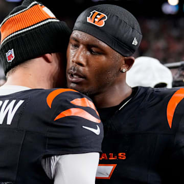 Cincinnati Bengals quarterback Joe Burrow (9) and wide receiver Tee Higgins (5) celebrate the win after overtime of the NFL Week 17 game between the Cincinnati Bengals and the Denver Broncos at Paycor Stadium in downtown Cincinnati on Saturday, Dec. 28, 2024. The Bengals took a 30-24 win in overtime to remain in the post season chase.