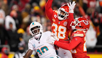 Jan 13, 2024; Kansas City, Missouri, USA; Kansas City Chiefs cornerback L'Jarius Sneed (38) and cornerback Trent McDuffie (22) break up a pass intended for Miami Dolphins wide receiver Tyreek Hill (10) during the second half of the 2024 AFC wild card game at GEHA Field at Arrowhead Stadium. Mandatory Credit: Jay Biggerstaff-Imagn Images