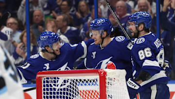Mar 27, 2025; Tampa, Florida, USA; Tampa Bay Lightning center Jake Guentzel (59) is congratulated by right wing Nikita Kucherov (86) and center Brayden Point (21)  after he scored on Utah Hockey Club goaltender Karel Vejmelka (70) during the first period at Amalie Arena. Mandatory Credit: Kim Klement Neitzel-Imagn Images