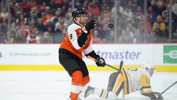 Philadelphia Flyers defenseman Cam York (8) reaches for the puck against the Pittsburgh Penguins in the first period 