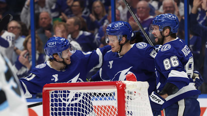 Mar 27, 2025; Tampa, Florida, USA; Tampa Bay Lightning center Jake Guentzel (59) is congratulated by right wing Nikita Kucherov (86) and center Brayden Point (21)  after he scored on Utah Hockey Club goaltender Karel Vejmelka (70) during the first period at Amalie Arena. Mandatory Credit: Kim Klement Neitzel-Imagn Images