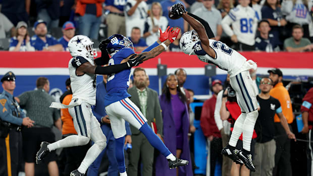 Dallas Cowboys cornerback Amani Oruwariye (27) intercepts a pass intended for New York Giants wide receiver Jalin Hyatt (13).