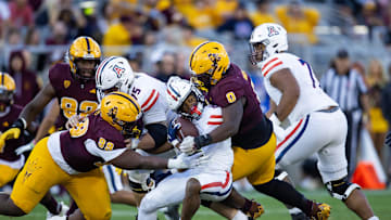 Nov 25, 2023; Tempe, Arizona, USA; Arizona State Sun Devils defensive lineman Dashaun Mallory (0) and defensive lineman C.J. Fite (99) tackle Arizona Wildcats running back Rayshon Luke (21) during the Territorial Cup at Mountain America Stadium. Mandatory Credit: Mark J. Rebilas-USA TODAY Sports