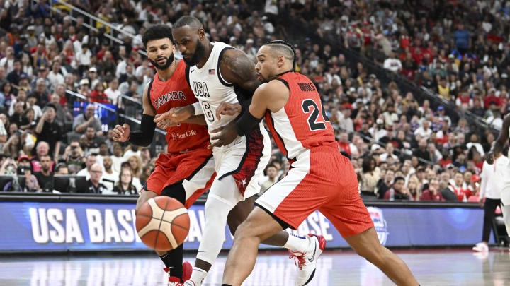 Jul 10, 2024; Las Vegas, Nevada, USA; USA forward Lebron James (6) collides with Canada guard Jamal Murray (4) and forward Dillion Brooks (24) in the first quarter of the USA Basketball Showcase at T-Mobile Arena. Mandatory Credit: Candice Ward-USA TODAY Sports