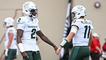 Oct 18, 2025; Bloomington, Indiana, USA; Michigan State Spartans quarterback Aidan Chiles (2) fist pumps Michigan State Spartans quarterback Alessio Milivojevic (11) prior to the game against the Indiana Hoosiers at Memorial Stadium. Mandatory Credit: Robert Goddin-Imagn Images