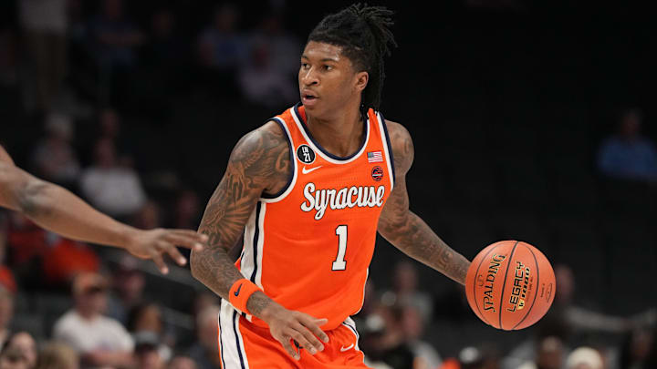 Mar 10, 2026; Charlotte, NC, USA; Syracuse Orange forward Donnie Freeman (1) with the ball as Southern Methodist University Mustangs guard Boopie Miller (2) defends in the first half at Spectrum Center. Mandatory Credit: Bob Donnan-Imagn Images