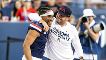 Nov 8, 2025; Tucson, Arizona, USA; Arizona Wildcats quarterback Noah Fifita (1) celebrates with offensive coordinator Seth Doege after defeating the Kansas Jayhawks at Arizona Stadium. Mandatory Credit: Mark J. Rebilas-Imagn Images