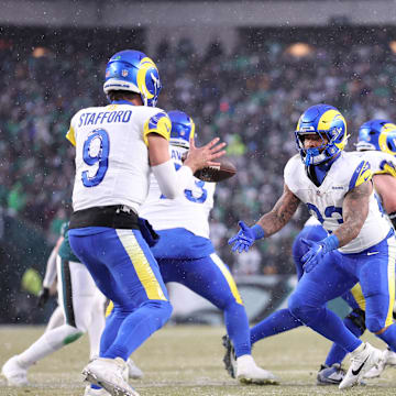 Jan 19, 2025; Philadelphia, Pennsylvania, USA; Los Angeles Rams running back Kyren Williams (23) tosses the ball back to Los Angeles Rams quarterback Matthew Stafford (9) during the second quarter against the Philadelphia Eagles in a 2025 NFC divisional round game at Lincoln Financial Field. Mandatory Credit: Bill Streicher-Imagn Images