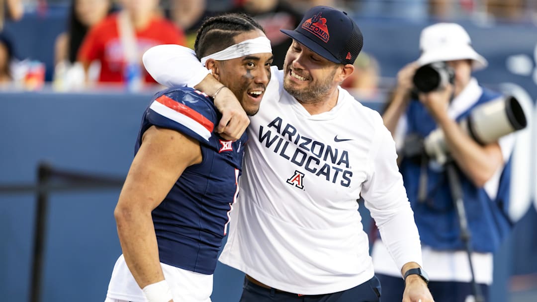 Nov 8, 2025; Tucson, Arizona, USA; Arizona Wildcats quarterback Noah Fifita (1) celebrates with offensive coordinator Seth Doege after defeating the Kansas Jayhawks at Arizona Stadium. Mandatory Credit: Mark J. Rebilas-Imagn Images