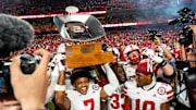 Nebraska defensive back Malcolm Hartzog Jr. hoists the Battle Sports Kansas City Classic trophy after his game-saving interception against Cincinnati.