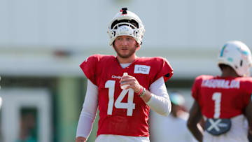 Jul 29, 2025; Miami Gardens, FL, USA; Miami Dolphins quarterback Quinn Ewers (14) hydrates during training camp at Baptist Health Training Complex. Mandatory Credit: Sam Navarro-Imagn Images