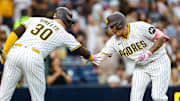 Sep 13, 2025; San Diego, California, USA; San Diego Padres third baseman Manny Machado (13) celebrates with designated hitter Gavin Sheets (30) after hitting a one run home run during the third inning against the Colorado Rockies at Petco Park. Mandatory Credit: David Frerker-Imagn Images