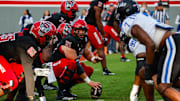 Nov 9, 2024; Raleigh, North Carolina, USA; North Carolina State Wolfpack center holds the ball during the first half of the game against Duke Blue Devils at Carter-Finley Stadium. Mandatory Credit: Jaylynn Nash-Imagn Images