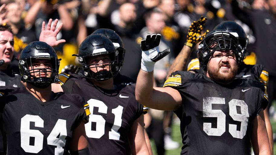 Iowa offensive linemen Leighton Jones, Cael Winter and Trevor Lauck wave to patients of the Stead Family Children’s Hospital.