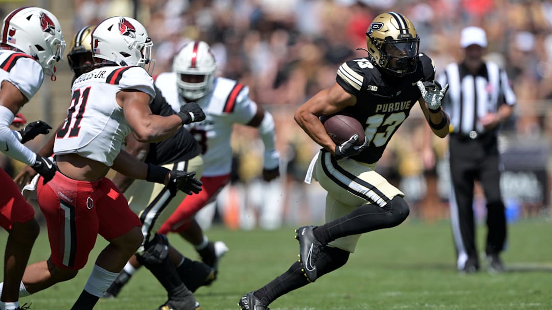 Aug 30, 2025; West Lafayette, Indiana, USA; Purdue Boilermakers wide receiver EJ Horton Jr. (13) runs the ball past Ball State Cardinals linebacker DeJuan Echoles Jr. (31) during the second half at Ross-Ade Stadium. Mandatory Credit: Marc Lebryk-Imagn Images