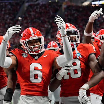 Georgia defensive back Daylen Everette (6) celebrates with his teammates after picking off a pass from Texas quarterback Quinn Ewers (3) during the second half of the SEC championship game against Texas in Atlanta, on Saturday, Dec. 7, 2024.