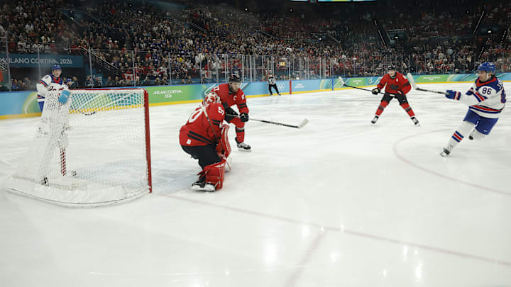 Feb 22, 2026; Milan, Italy; Jack Hughes #86 of Team United States scores the golden goal on Jordan Binnington #50 of Team Canada in overtime during the Milano Cortina 2026 Olympic Winter Games at Milano Santagiulia Ice Hockey Arena. Mandatory Credit: Geoff Burke-Imagn Images