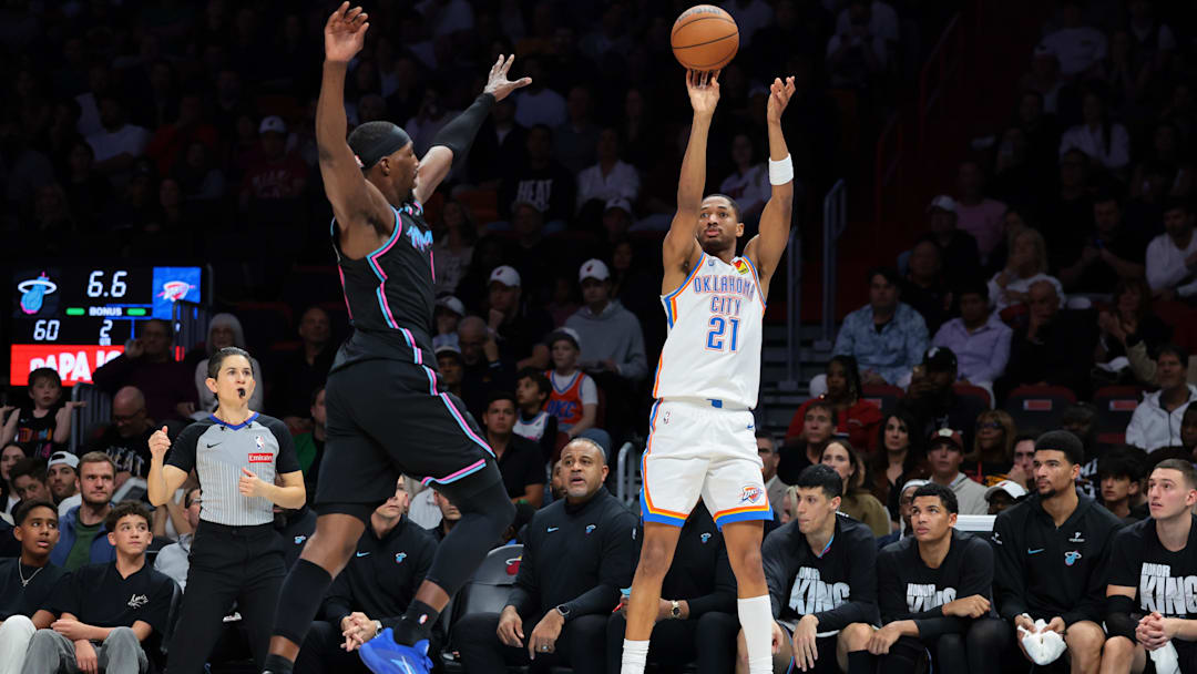 Jan 17, 2026; Miami, Florida, USA; Oklahoma City Thunder guard Aaron Wiggins (21) shoots the basketball against Miami Heat center Bam Adebayo (13) during the second quarter at Kaseya Center. Mandatory Credit: Sam Navarro-Imagn Images