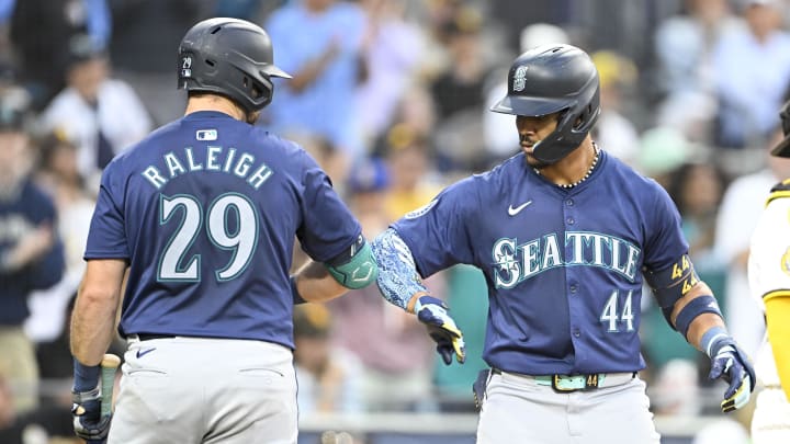 Seattle Mariners center fielder Julio Rodriguez (44) is congratulated by Cal Raleigh after hitting a solo home run during the fifth inning against the San Diego Padres on July 9.