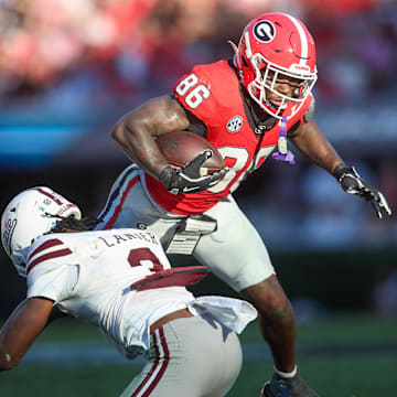 Oct 12, 2024; Athens, Georgia, USA; Georgia Bulldogs wide receiver Dillon Bell (86) is tackled by Mississippi State Bulldogs safety Brylan Lanier (3) in the second quarter at Sanford Stadium. Mandatory Credit: Brett Davis-Imagn Images