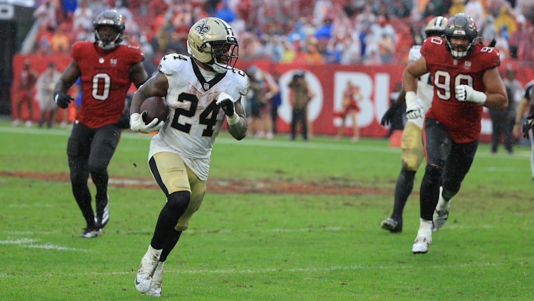Dec 7, 2025; Tampa, Florida, USA; New Orleans Saints running back Devin Neal (24) runs for a gain during the third quarter against the Tampa Bay Buccaneers at Raymond James Stadium. Mandatory Credit: Kim Klement Neitzel-Imagn Images