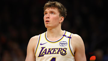 Nov 26, 2024; Phoenix, Arizona, USA; Los Angeles Lakers guard Dalton Knecht (4) against the Phoenix Suns during an NBA Cup game at Footprint Center. Mandatory Credit: Mark J. Rebilas-Imagn Images