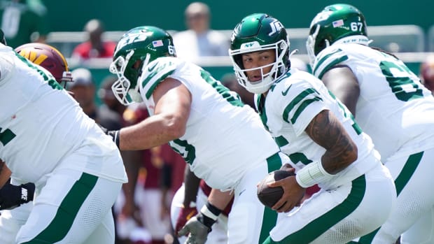 New York Jets quarterback Adrian Martinez (15) receives a snap during the second half