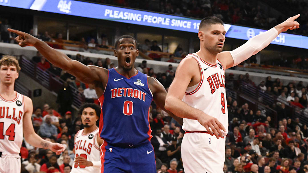 Oct 22, 2025; Chicago, Illinois, USA; Chicago Bulls center Nikola Vucevic (9)  and Detroit Pistons center Jalen Duren (0) point for possession after a rebound went out of bounds during the second half at United Center.