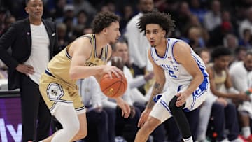 Mar 13, 2025; Charlotte, NC, USA; Georgia Tech Yellow Jackets guard Lance Terry (0) dribbles defended by Duke Blue Devils guard Tyrese Proctor (5) during the second half at Spectrum Center. Mandatory Credit: Jim Dedmon-Imagn Images