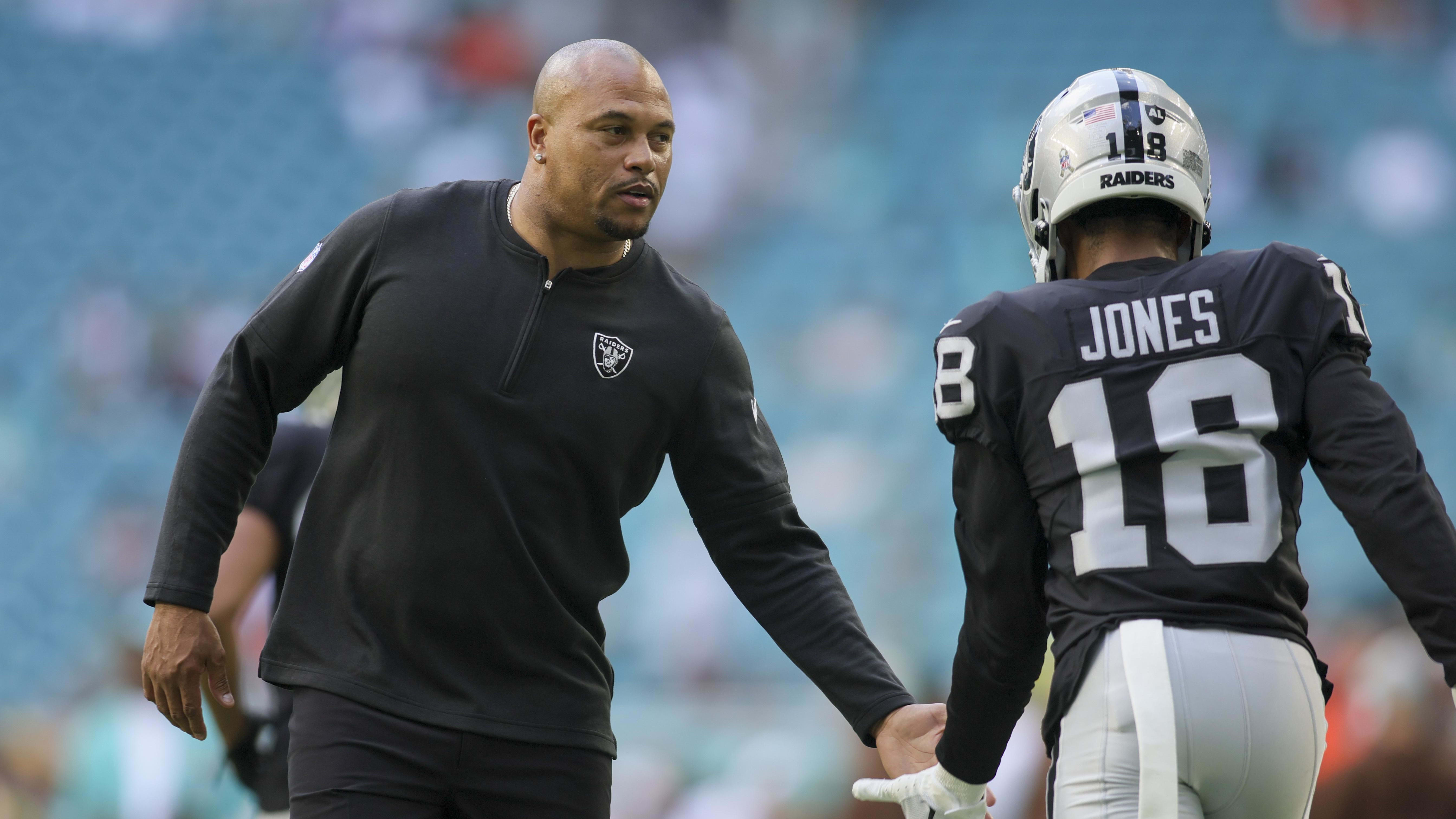 Las Vegas Raiders coach Antonio Pierce greets a player before a game vs. the Miami Dolphins.