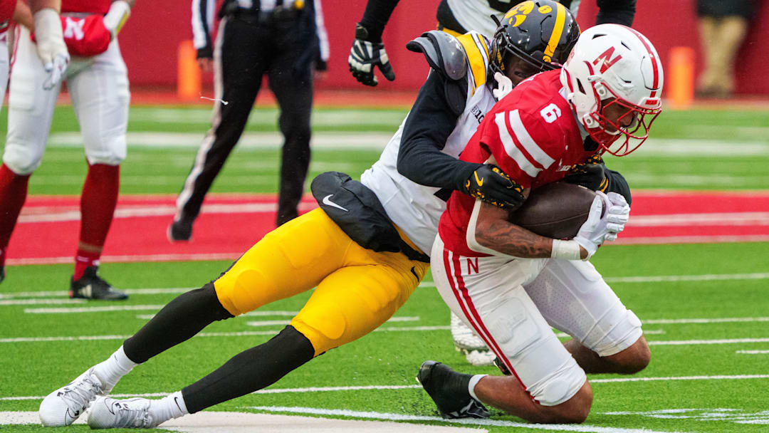 Nov 28, 2025; Lincoln, Nebraska, Nebraska Cornhuskers wide receiver Dane Key (6) is tackled by Iowa Hawkeyes defensive back Rashad Godfrey Jr. (7) during the fourth quarter at Memorial Stadium. 