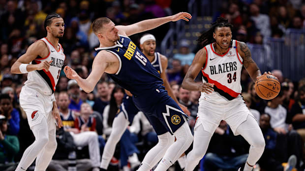 Feb 12, 2025; Denver, Colorado, USA; Portland Trail Blazers forward Jabari Walker (34) grabs a loose ball against Denver Nugg