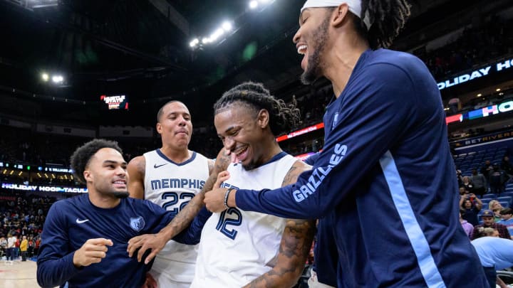 Dec 19, 2023; New Orleans, Louisiana, USA; Memphis Grizzlies guard Ja Morant, center, is mobbed by teammates Jacob Gilyard, left, and Ziaire Williams, after scoring the winning basket to defeat the New Orleans Pelicans at the Smoothie King Center. 