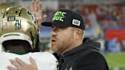 Nov 1, 2024; Boca Raton, Florida, USA;  South Florida Bulls head coach Alex Golesh (right) greets Bulls cornerback Jarvis Lee (28) before the game against the Florida Atlantic Owls at FAU Stadium. Mandatory Credit: Reinhold Matay-Imagn Images