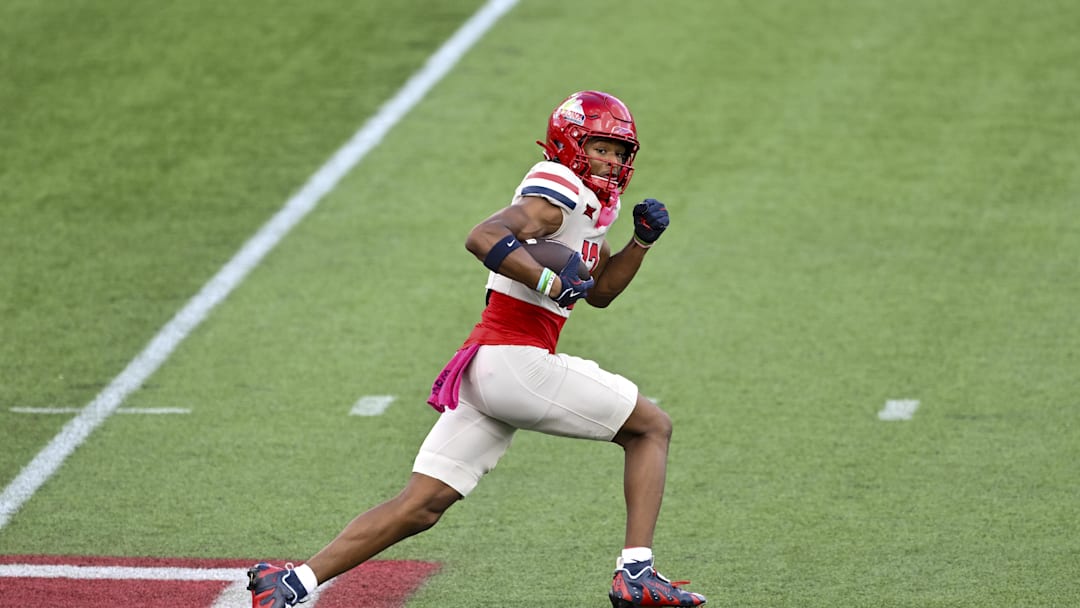 Oct 18, 2025; Houston, Texas, USA; Arizona Wildcats wide receiver Tre Spivey (12) runs the ball during the first quarter against the Houston Cougars at TDECU Stadium. Mandatory Credit: Maria Lysaker-Imagn Images 
