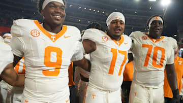 Tennessee defensive linemen Mariyon Dye (9) and Ethan Utley (17), and offensive lineman David Sanders Jr. (70) celebrate the win over Florida in an NCAA college football game on November 22, 2025, in Gainesville, Florida.