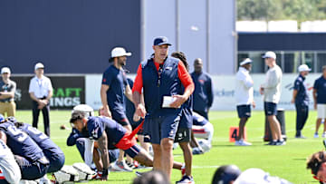 Jul 23, 2025; Foxborough, MA, USA; New England Patriots head coach Mike Vrabel walks though plays warming up before day one of training camp at Gillette Stadium. Mandatory Credit: Eric Canha-Imagn Images