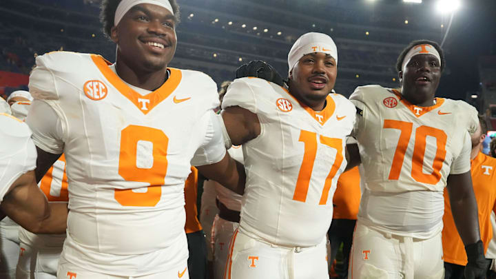 Tennessee defensive linemen Mariyon Dye (9) and Ethan Utley (17), and offensive lineman David Sanders Jr. (70) celebrate the win over Florida in an NCAA college football game on November 22, 2025, in Gainesville, Florida.