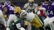 Green Bay Packers linebacker Edgerrin Cooper (56) tackles Minnesota Vikings running back Aaron Jones for a loss.