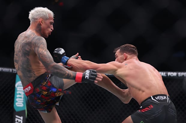 Charles Oliveira (red gloves) fights Michael Chandler (blue gloves) in the lightweight bout during UFC 309.