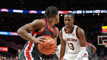 Dec 14, 2024; Atlanta, Georgia, USA; Auburn Tigers guard Miles Kelly (13) guards Ohio State Buckeyes guard Meechie Johnson Jr. (1) during the first half at State Farm Arena. Mandatory Credit: Jordan Godfree-Imagn Images