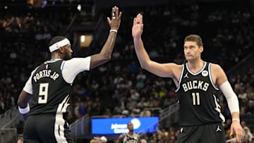 Milwaukee Bucks center Brook Lopez high five forward Bobby Portis during the second quarter against the Toronto Raptors at Fiserv Forum on November 12, 2024.