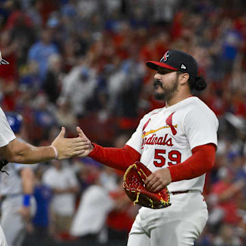 Aug 10, 2025; St. Louis, Missouri, USA;  St. Louis Cardinals relief pitcher JoJo Romero (59) celebrates with catcher Pedro Pages (43) after the Cardinals defeated the Chicago Cubs at Busch Stadium. Mandatory Credit: Jeff Curry-Imagn Images
