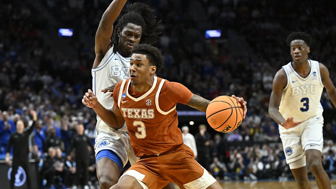 Mar 19, 2026; Portland, OR, USA; Texas Longhorns forward Dailyn Swain (3) drives against BYU Cougars forward Khadim Mboup (7) in the second half during a first round game of the men's 2026 NCAA Tournament at Moda Center. Mandatory Credit: Craig Strobeck-Imagn Images